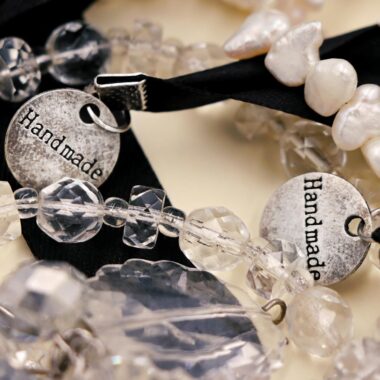 Detailed close-up of handmade beaded bracelets featuring crystal beads and handmade tags.