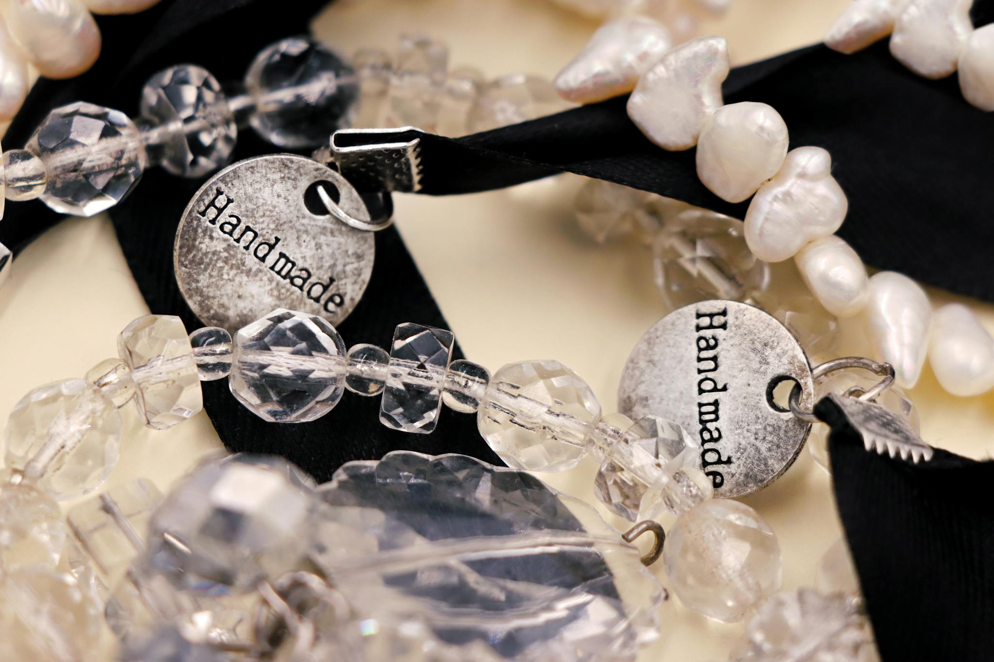 Detailed close-up of handmade beaded bracelets featuring crystal beads and handmade tags.
