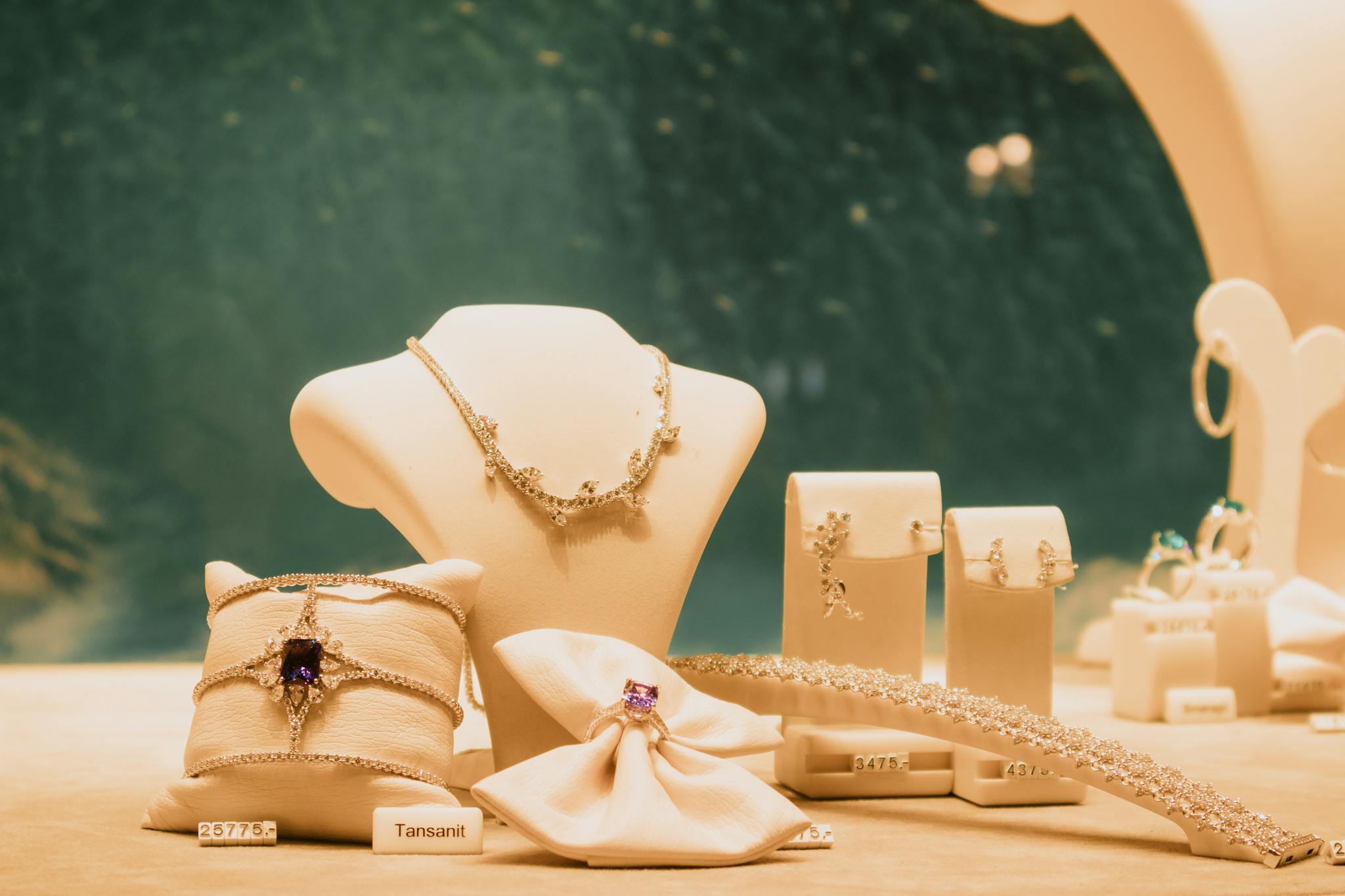 Luxury jewelry set elegantly displayed with necklaces and rings in a store setting.